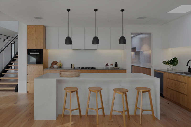 Bright kitchen extension with island seating and pendant lights